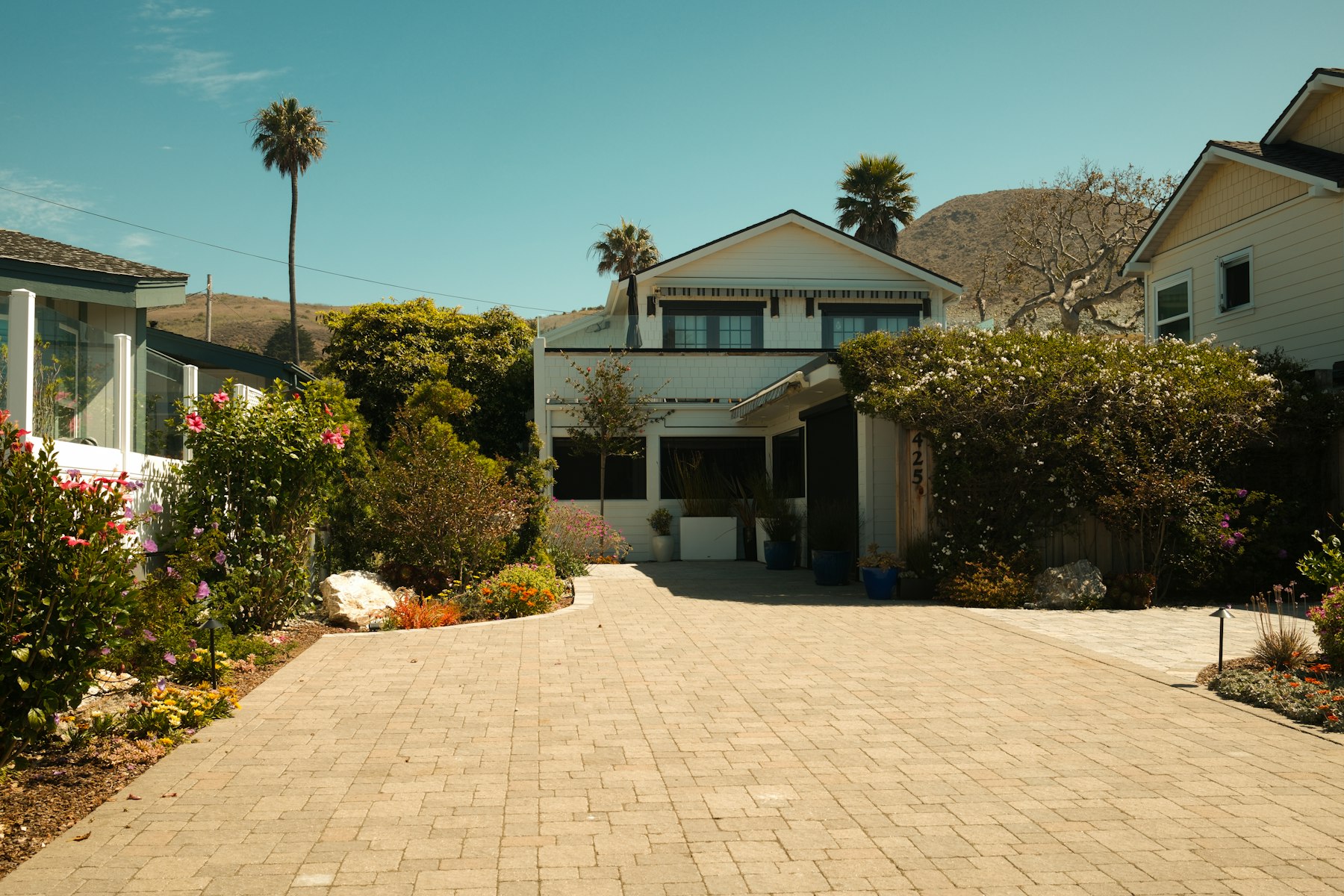 White house with a long paved driveway